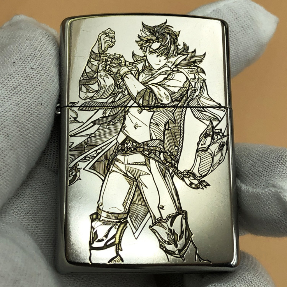 Front view of a Zippo lighter engraved with Childe (Tartaglia) from Genshin Impact in a dynamic action pose.